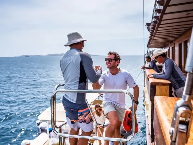 Crew and guests on the deck of a Komodo boat